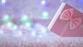 Christmas gift box of soft pink color on a defocused background with burning lights of a garland. Christmas background. Free space Royalty Free Stock Photo