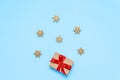 Christmas gift box tied with a red ribbon on a blue background with Golden snowflakes, Christmas and New year Greeting card Royalty Free Stock Photo