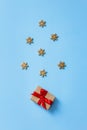 Christmas gift box tied with a red ribbon on a blue background with Golden snowflakes, Christmas and New year Greeting card Royalty Free Stock Photo