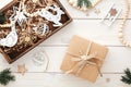 Christmas gift box, wooden tray with vintage decorations, wooden ornaments, fir branches on white wood desk table Royalty Free Stock Photo