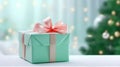 Christmas gift box wrapped in turquoise paper tied with silk ribbon golden garland lights. Decorated Christmas tree Royalty Free Stock Photo