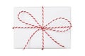 Christmas gift box wrapped in white paper with striped string bow isolated on white background Royalty Free Stock Photo