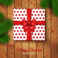 Christmas Gift Box Wrapping with Red Bow and Polka Dot Paper. Royalty Free Stock Photo