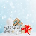 Christmas gift boxes against light blue bokeh background. Holiday greeting card with copy space. Royalty Free Stock Photo