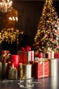 Christmas gift boxes with chistmas tree lights on background. Royalty Free Stock Photo