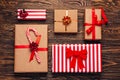 Christmas gift boxes collection in craft paper with red ribbons on rustic dark wooden background. Preparation for holidays. Top Royalty Free Stock Photo