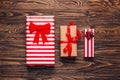 Christmas gift boxes collection in craft paper with red ribbons on rustic dark wooden background. Preparation for holidays. Top Royalty Free Stock Photo