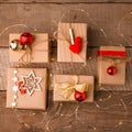 Christmas gift boxes collection with red decor on vintage wooden background. Classial preparation holiday. View from above. Royalty Free Stock Photo