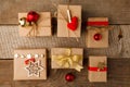 Christmas gift boxes collection with red decor on vintage wooden background. Classial preparation holiday. View from above. Royalty Free Stock Photo