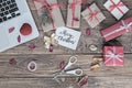 Christmas Gift Boxes and cropped computer on vintage wood Background