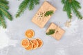 Christmas gift boxes with dry orange slices and green fir tree branches