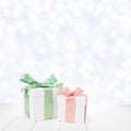 Christmas gift boxes with pastel green and rose ribbon with a silver twinkling light background Royalty Free Stock Photo