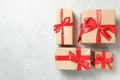 Christmas gift boxes with red bows on grey marble background, flat lay. Space for text Royalty Free Stock Photo