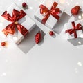 Christmas gift boxes with red ribbon and decoration on white background with bokeh, light. Xmas and Happy New Year holiday. Flat Royalty Free Stock Photo