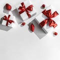 Christmas gift boxes with red ribbon and decoration on white background. Xmas and Happy New Year holiday, bokeh, light. Flat lay Royalty Free Stock Photo