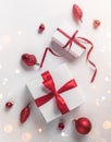 Christmas gift boxes with red ribbon and decoration on white background. Xmas and Happy New Year theme, snow. Flat lay Royalty Free Stock Photo