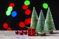 Christmas gift boxes under pine tree on wooden table over bokeh background Royalty Free Stock Photo