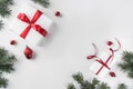 Christmas gift boxes on white background with Fir branches, pine cones, red ribbon. Royalty Free Stock Photo