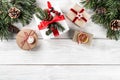 Christmas gift boxes on white wooden background with Fir branches, pine cones. Royalty Free Stock Photo