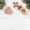 Christmas gift boxes on white wooden background with Fir branches, pine cones. Xmas and Happy New Year theme. Royalty Free Stock Photo