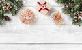 Christmas gift boxes on white wooden background with Fir branches, pine cones. Royalty Free Stock Photo