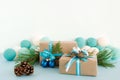Christmas gift boxes wrapped of craft paper, blue and white ribbons, decorated of fir branches, pine cones and Christmas balls. Royalty Free Stock Photo