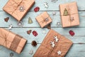 Christmas gift boxes wrapped in kraft paper on blue wooden table. Zero waste, eco friendly packaging Royalty Free Stock Photo