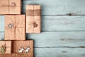 Christmas gift boxes wrapped in kraft paper on blue wooden table. Zero waste, eco friendly packaging Royalty Free Stock Photo