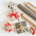 Christmas gift boxes wrapped in kraft paper and paper rolls for DIY presents wrapping Royalty Free Stock Photo