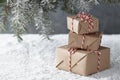 Christmas gift boxes wrapped in kraft paper under fir tree Royalty Free Stock Photo