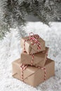 Christmas gift boxes wrapped in kraft paper under fir tree Royalty Free Stock Photo