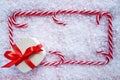 Christmas gift candy cane frame on snow Royalty Free Stock Photo