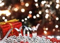 Christmas gift and decorations on defocussed bokeh lights background