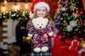 Christmas gift she dreamed about. Best gift ever. Happy new year concept. Dreams come true. Kid near christmas tree hold