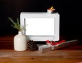 Christmas gift with empty picture frame on wooden table Royalty Free Stock Photo