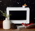 Christmas gift with empty picture frame on wooden table Royalty Free Stock Photo