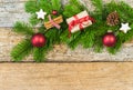 Christmas gift with fir tree branch and decoration on wood background Royalty Free Stock Photo