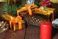 Christmas gift gold, red box with gold color bow and candles. Christmas decoration. Royalty Free Stock Photo