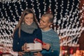 Christmas gift, happy couple with Christmas and New Year gift on street Royalty Free Stock Photo