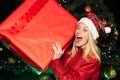 Christmas gift. Happy woman with big red box. Smiling girl in winter. Funny. Happy new year. Home Holiday. Merry xmas