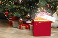 Christmas gift with magic light and blurred lights. Royalty Free Stock Photo