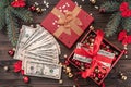 A Christmas gift, money, Christmas items, on a wooden background. Top view