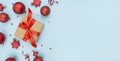 Christmas gift with New Year`s red balls on a blue background. Christmas card. New Year`s banner. Flat layer. Top view with copy Royalty Free Stock Photo