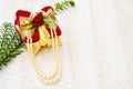 Christmas gift and pearls on old lace Royalty Free Stock Photo