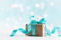 Christmas gift or present box against turquoise bokeh background. Holiday greeting card. Royalty Free Stock Photo