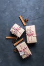 Christmas gift or present box wrapped in kraft paper with decoration on dark background. Present decorated with christmas cookies Royalty Free Stock Photo
