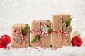 Christmas gift or present box wrapped in kraft paper with decoration on white background. Royalty Free Stock Photo