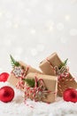 Christmas gift or present box wrapped in kraft paper with decoration on white background. Present decorated with natural parts. Royalty Free Stock Photo