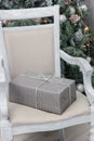 Christmas gift at silver box on the chair. Royalty Free Stock Photo
