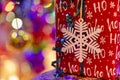 Christmas gift with a snowflake and colorful blurred lights